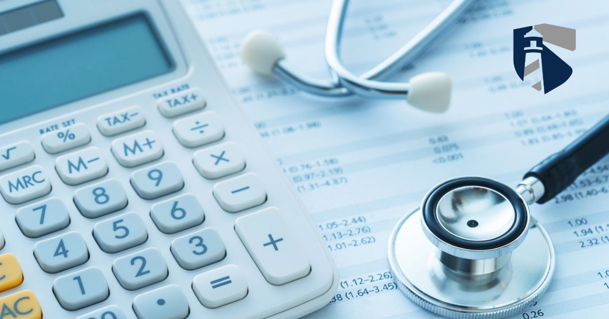 Stethoscope and calculator on top of medical bills